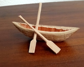 miniature rowing boat with ores mini rowing boat tiny boat ores beach wooden miniature boat ship