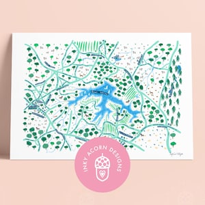May include: A hand-drawn map of a lake and surrounding area, with trees, houses, and roads. The map is in shades of green, blue, and white. The text "Inky Acorn Designs" is in a pink circle at the bottom of the map.