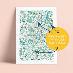 May include: A detailed illustrated map of London, featuring a blue river and green parks. The print includes various buildings and landmarks in a colorful design. Text on the print says "Personalised with your postcode/s".