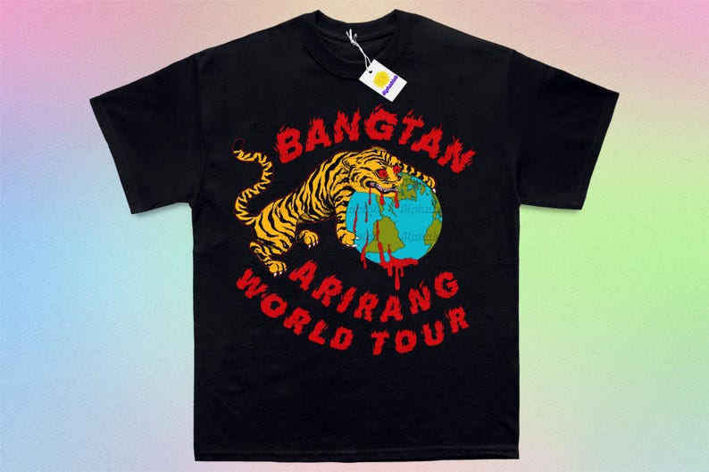 May include: Black t-shirt featuring a tiger with yellow and black stripes biting a globe. The globe has blue oceans and red blood dripping from it. Text in red reads "BANGTAN ARIRANG WORLD TOUR". A white tag hangs from the collar.