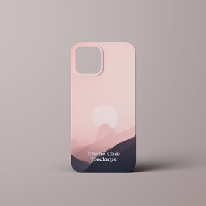 May include: A pink phone case with a mountain and sunset design. The case has a cutout for the camera lens and the text "Phone Case Mockups" printed on the bottom.
