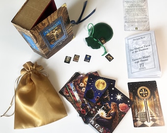 May include: A tarot card deck set titled The Magical Tarot of the Gnomes, featuring a wooden-textured box, a gold satin drawstring bag, a green velvet pouch, a small instruction booklet, and several illustrated cards with celestial imagery.