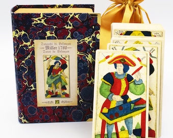 May include: A vintage tarot deck with a marbled book box and a gold fabric bag. The cards feature colorful illustrations of people and objects. The text on the cards reads "Le Bateleur" and "Tarot de Belançon Miller 1780".