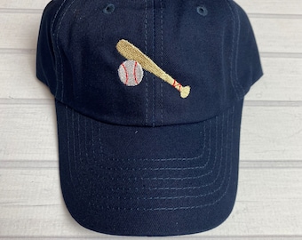 May include: A navy blue baseball cap with an embroidered baseball and bat design.