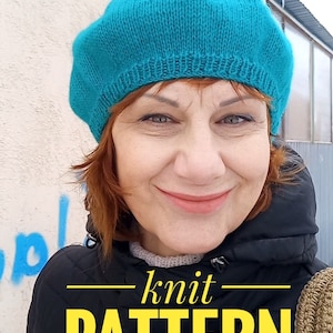 May include: A woman wearing a teal blue knitted beret and a black jacket. The text "knit PATTERN" is written in yellow letters on the jacket.