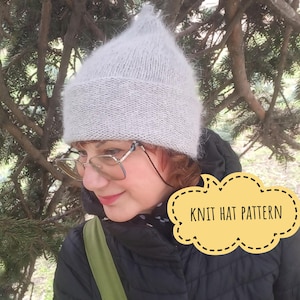 May include: A light gray knit hat with a pointed top. The hat is worn by a person wearing glasses and a black jacket. A yellow speech bubble with the text "KNIT HAT PATTERN" is in the image.