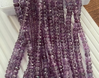 May include: A strand of purple amethyst beads, faceted and cut into a rectangular shape. The beads are strung together on a clear thread.