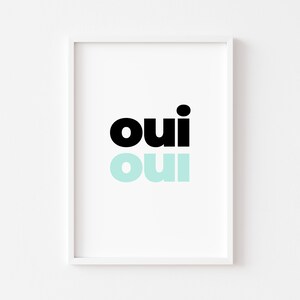 May include: A white framed print with the word "oui" in black and a lighter blue color.