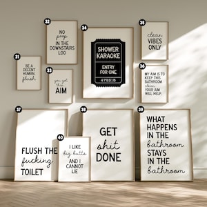 May include: A collection of framed bathroom art prints with humorous quotes in black text on a white background. The prints feature phrases like "Shower Karaoke," "Get Shit Done," and "Clean Vibes Only."