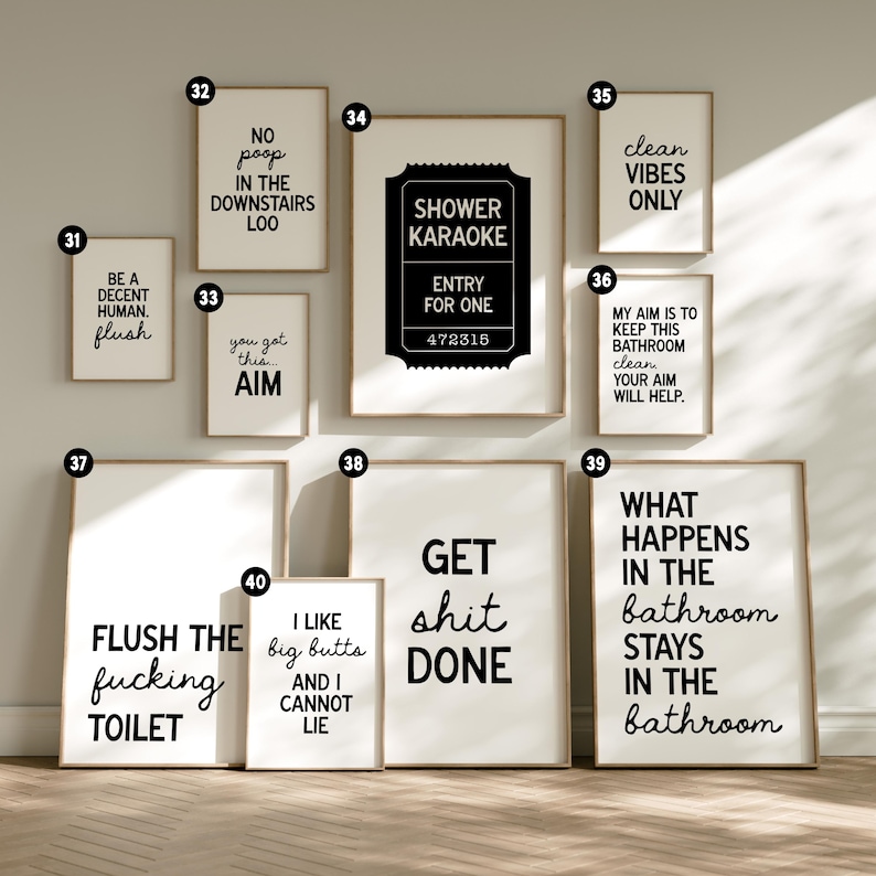 May include: A collection of framed bathroom art prints with humorous quotes in black text on a white background. The prints feature phrases like "Shower Karaoke," "Get Shit Done," and "Clean Vibes Only."