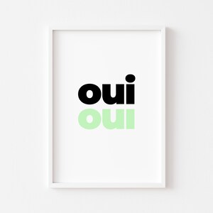 May include: A framed print with the word "oui" written twice, once in black and once in light green.