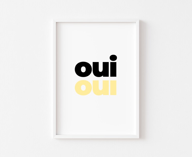 May include: A white framed print with the word "oui" in black and yellow lettering.