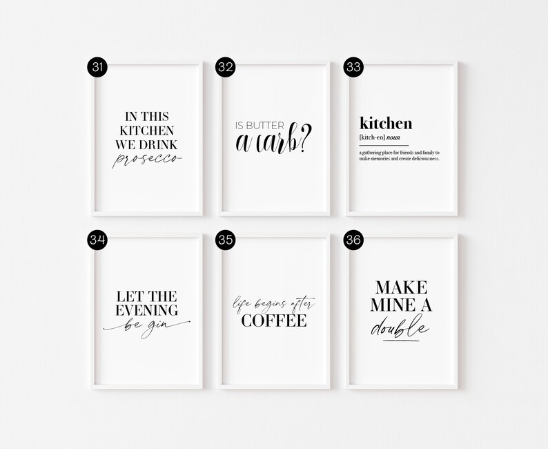 May include: Six white framed prints with black text on a white background. The prints feature kitchen-themed quotes and sayings, such as "In this kitchen we drink prosecco" and "Life begins after coffee".