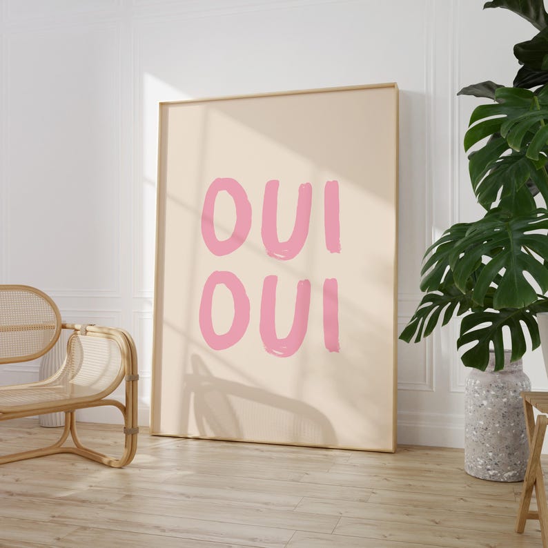 May include: A beige poster with the text "OUI OUI" written in pink.