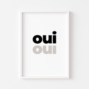 May include: A white framed print with the word "oui" in black and gray text.
