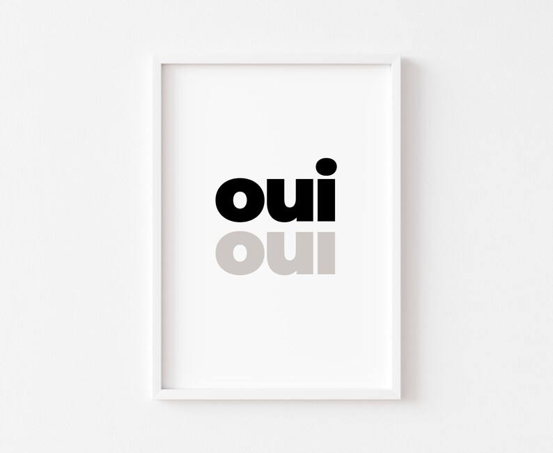 May include: A white framed print with the word "oui" in black and gray text.