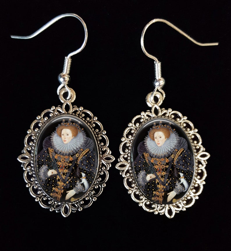 May include: Silver filigree earrings with oval glass cabochons featuring a portrait of Queen Elizabeth I in a black and gold gown with a white ruff.