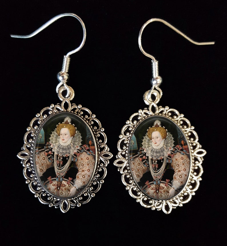 May include: Silver earrings with a cameo of Queen Elizabeth I in an oval frame. The cameo is set in a silver filigree frame.