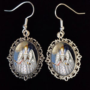 May include: Silver oval earrings featuring a portrait of Queen Elizabeth I in a white and gold dress against a blue background.