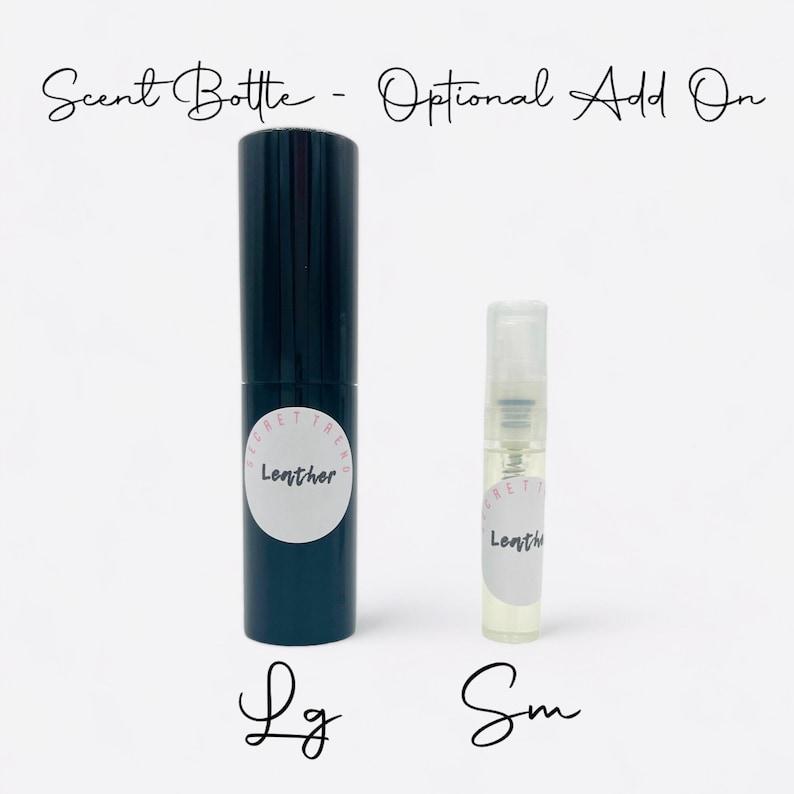 May include: Two glass bottles with spray tops. The larger bottle is black with a white label that says "Secret Trend Leather". The smaller bottle is clear with a white label that says "Secret Trend Leather". The bottles are labeled "Lg" and "Sm" respectively.