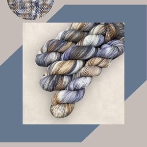May include: A skein of hand-dyed yarn in shades of blue, brown, and white. The image includes the text "HAND DYED YARN" and "COASTAL CREATIVE LINCS". The text "Frosted Heather DK or 4Ply/Sock" is also visible.