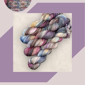 May include: A skein of hand-dyed yarn with a mix of colours: blue, pink, brown, and yellow. The image includes the text "HAND DYED YARN" and "COASTAL CREATIVE LINCS". The product is labelled "Vintage Bloom DK or 4Ply/Sock", with a weight of 50g or 100g.