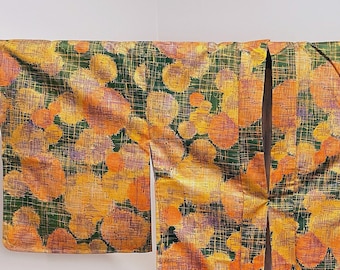 May include: A traditional Japanese kimono with a green and orange abstract pattern. The kimono is made of a lightweight fabric and has a relaxed fit.