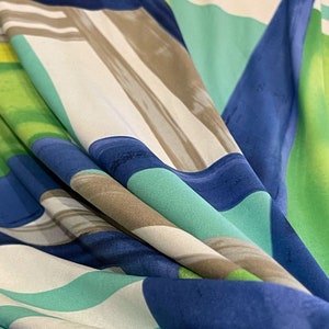 May include: Abstract fabric with a geometric pattern in shades of blue, green, and white.