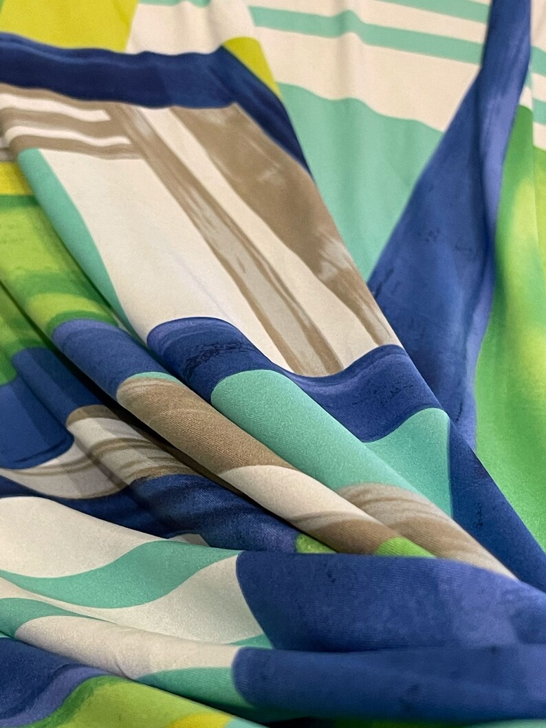 May include: Abstract fabric with a geometric pattern in shades of blue, green, and white.