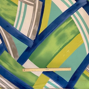 May include: Abstract fabric with a geometric pattern in shades of blue, green, yellow, and white. The fabric has a brushstroke effect and is perfect for crafting projects.
