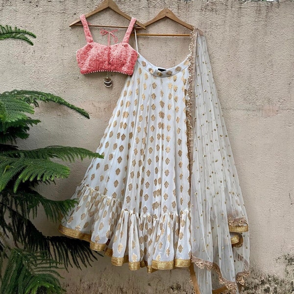 Bustier strap blouse with ivory butti georgette ruffle skirt and ivory sequin net dupatta with scalloped edging