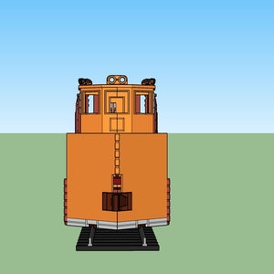 May include: A yellow and orange train engine with a black front bumper and a black roof. The engine has a single window on each side and a small door in the front.