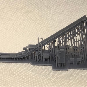 May include: A gray 3D printed model of a conveyor belt system with a long, angled belt and a complex framework of supports and machinery.