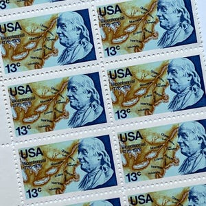 May include: Sheet of vintage USA Bicentennial stamps. Each stamp features a portrait of Benjamin Franklin, a map, and the text "USA Bicentennial 1776-1976" and "13¢". The stamps are blue, brown, and white.