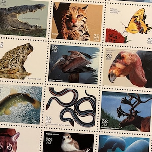 May include: Sheet of vintage 32-cent USA postage stamps featuring various wildlife. Stamps depict an American crocodile, ocelot, Wyoming toad, brown pelican, Schaus swallowtail butterfly, California condor, San Francisco garter snake, and woodland caribou.