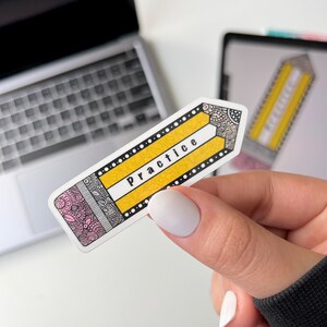 May include: A yellow and black pencil sticker with a white outline and the word "Practice" written in black letters. The sticker has a pink and black patterned design on the bottom.