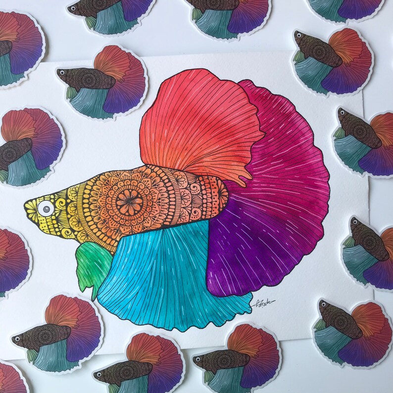May include: A colorful, hand-painted betta fish with intricate mandala patterns on its body. The fish is depicted in a vibrant palette of red, orange, yellow, blue, purple, and green. The artwork is framed by a white border.