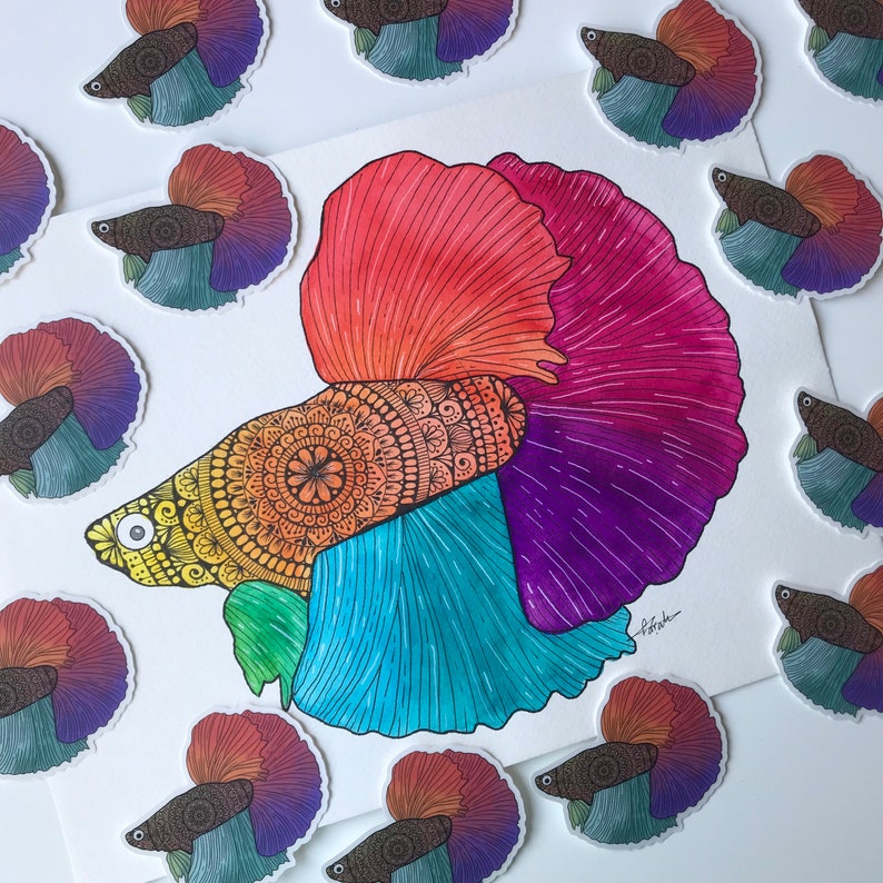 May include: A colorful watercolor painting of a betta fish with intricate mandala patterns on its body. The fish is depicted with a red, pink, purple, blue, and yellow color scheme. The painting is surrounded by smaller images of betta fish in various colors.