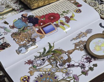 May include: Open book with decorative illustrations featuring flowers, vases, and ornate jewelry. A gold-framed picture and a vintage compact are also visible. The pages have French text.