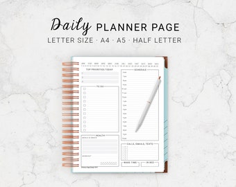 May include: A white daily planner page with a copper spiral binding. The page is divided into sections for top priorities, to do, schedule, health, calls, emails, texts, wake time, and in bed. The page also includes a calendar for the year.