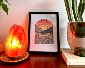 Original limited edition lino print, hand carved, hand printed, of a sunset over mountains with a river and house “View of the House“