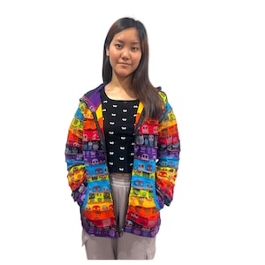 May include: A colorful hooded jacket with a rainbow stripe pattern and a small owl print. The jacket has a zipper closure and pockets.