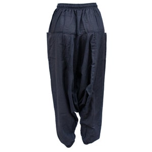 May include: Dark blue, loose-fitting pants with a drawstring waist and side pockets. The pants are made of a soft, comfortable fabric and have a relaxed, flowy fit.