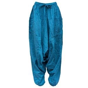 May include: A pair of blue cotton pants with a drawstring waist and side pockets. The pants are loose fitting and have a baggy style.