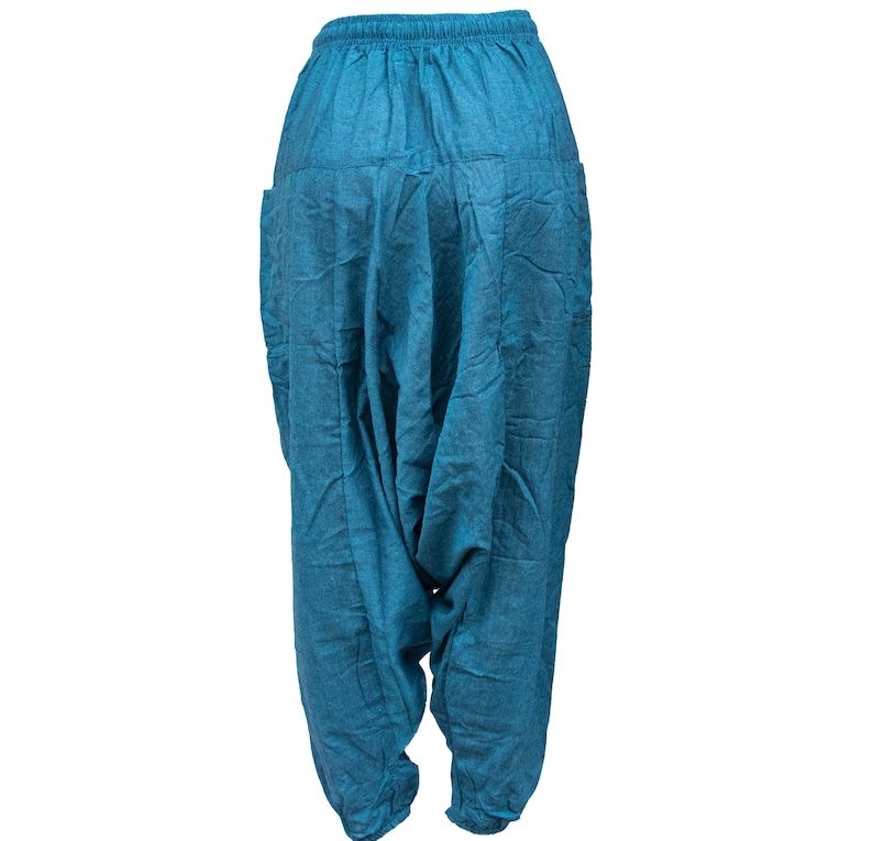May include: Teal blue cotton pants with a loose, baggy fit and a drawstring waist.