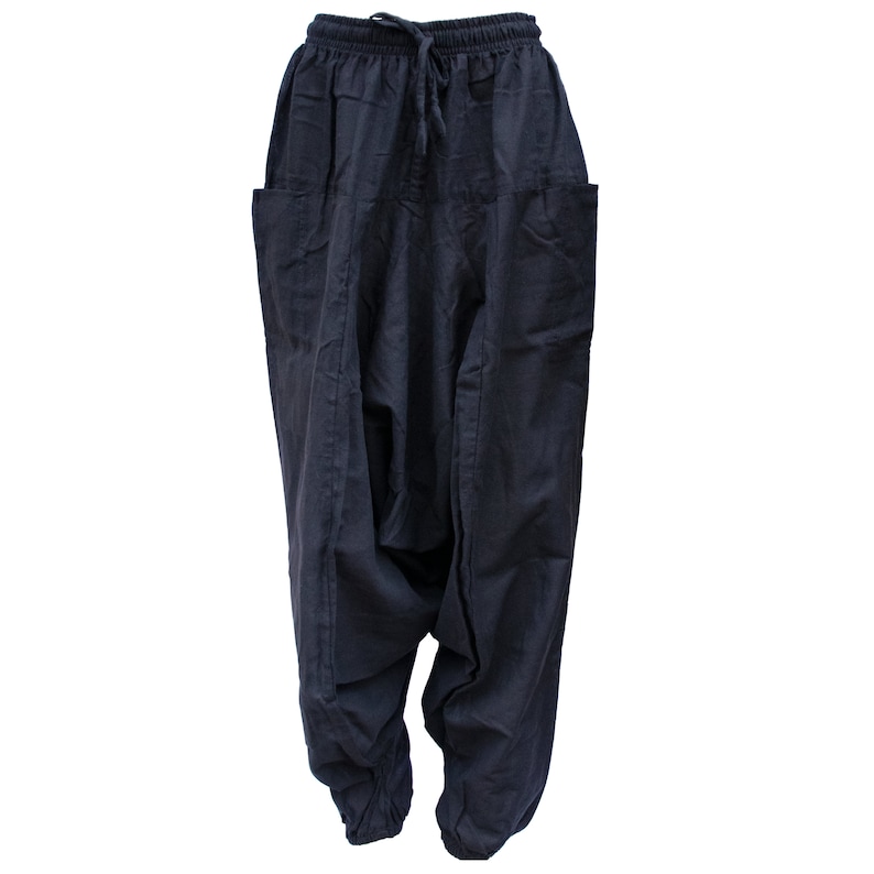 May include: Black cotton pants with a loose, baggy fit and a drawstring waistband.
