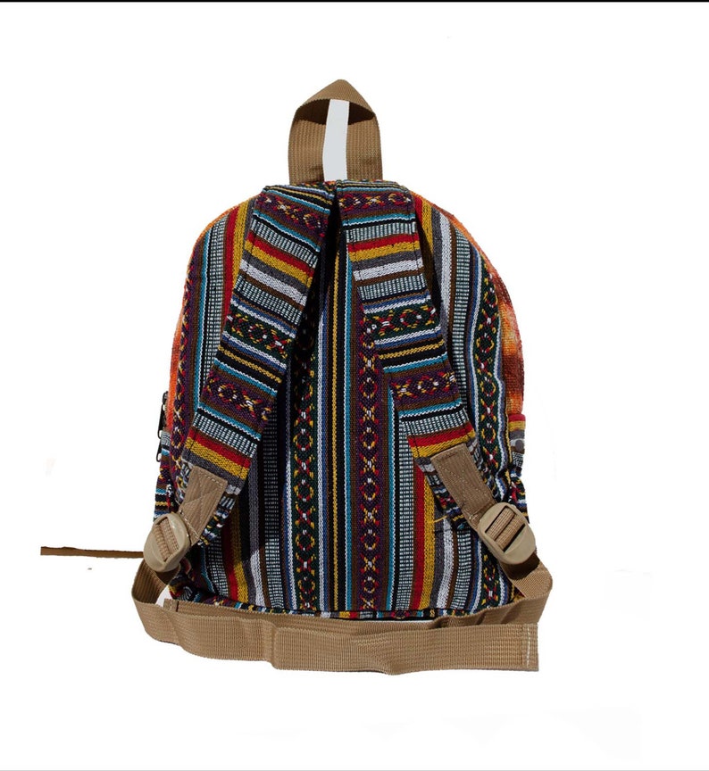 May include: A multi-colored striped backpack with a brown strap and buckle. The backpack is made of woven fabric and has a geometric pattern.