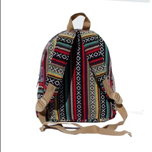 May include: A colorful striped backpack with a black background and tan straps. The backpack has a geometric pattern with red, yellow, blue, and green stripes.