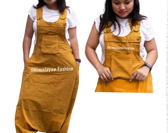 May include: A mustard yellow jumpsuit with a white top and two large pockets. The jumpsuit has a relaxed fit and is made of a soft, comfortable fabric. The text "@Himalayan Fashion" is visible on the jumpsuit.