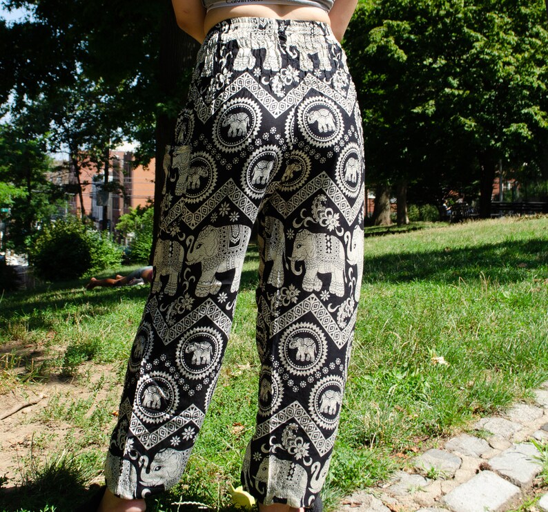 May include: Black and white patterned pants with an elephant design. The pants are loose fitting and have a wide leg.